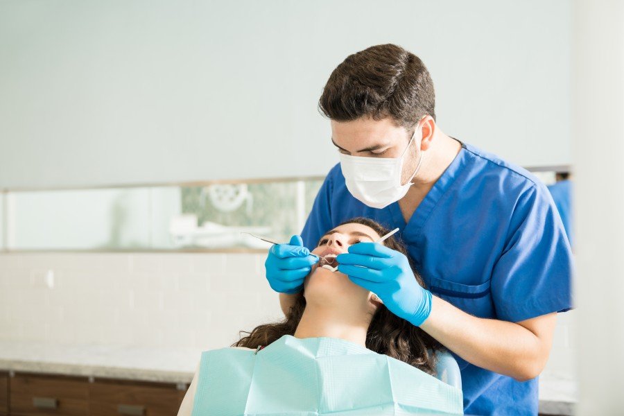 Dentist performing a routine dental examination on a patient
