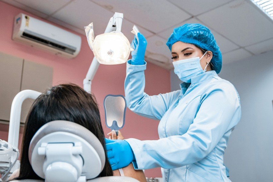 Dentist examining a girl’s teeth during a dental checkup