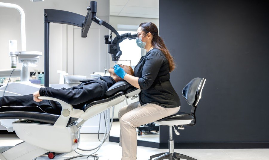 Dentist examining a patient during a dental implant consultation